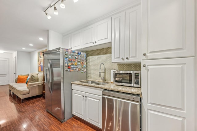 kitchen with backsplash, dark wood-type flooring, white cabinets, sink, and appliances with stainless steel finishes