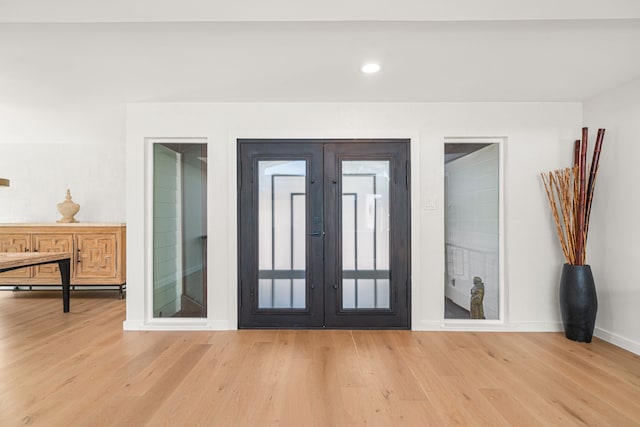 entryway featuring light hardwood / wood-style flooring and french doors