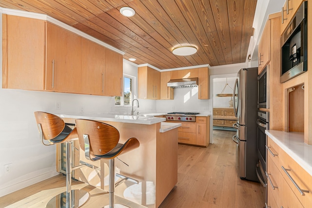 kitchen featuring range hood, light hardwood / wood-style floors, a breakfast bar, appliances with stainless steel finishes, and wooden ceiling