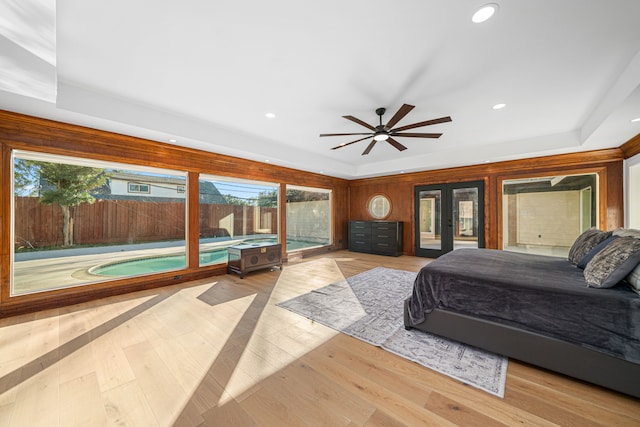 bedroom with ceiling fan, access to exterior, and light hardwood / wood-style flooring