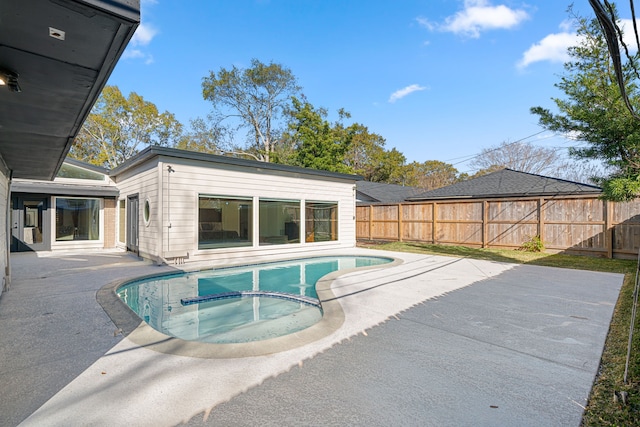 view of swimming pool featuring a patio area and an in ground hot tub