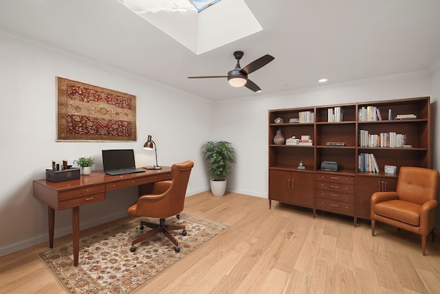 office area with light wood-type flooring, ceiling fan, and crown molding