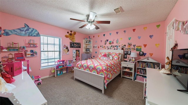 carpeted bedroom featuring a textured ceiling and ceiling fan