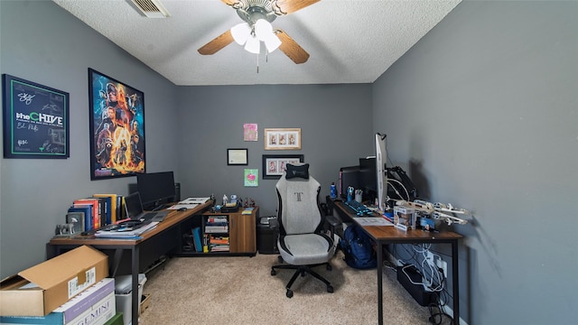 office area with ceiling fan, light colored carpet, and a textured ceiling