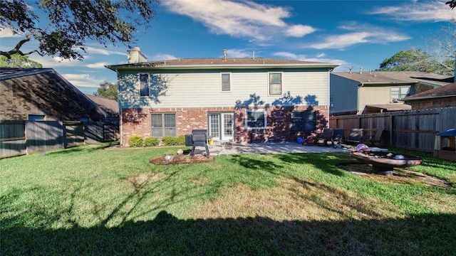 back of property featuring a yard and a patio