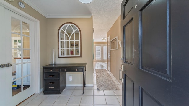 tiled foyer entrance featuring crown molding, french doors, and a textured ceiling