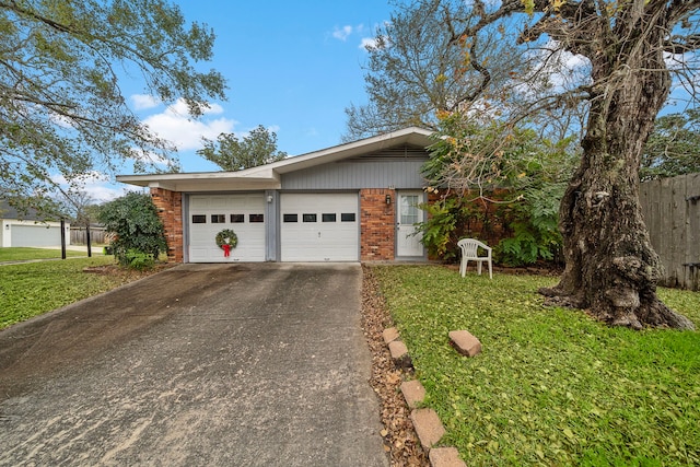 ranch-style home featuring a front lawn and a garage