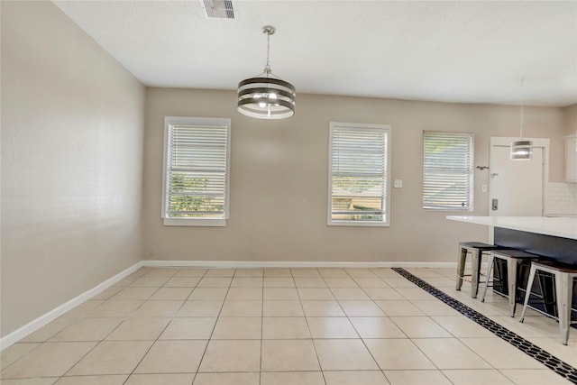 dining room featuring light tile patterned floors and an inviting chandelier