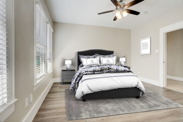 bedroom with hardwood / wood-style floors and ceiling fan