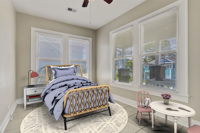 bedroom with ceiling fan, light tile patterned flooring, and multiple windows