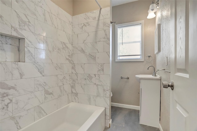 bathroom featuring vanity and tiled shower / bath