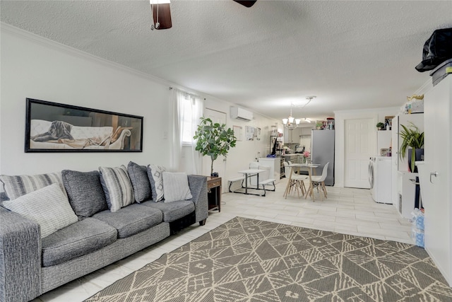 living room featuring ceiling fan with notable chandelier, a textured ceiling, a wall mounted AC, crown molding, and washer / dryer