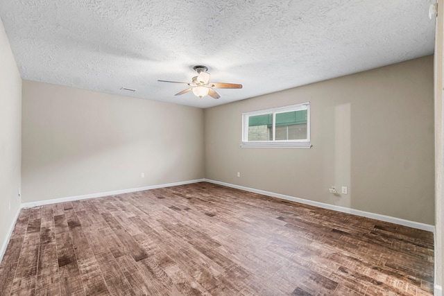 spare room with ceiling fan, wood-type flooring, and a textured ceiling