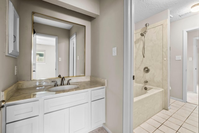 bathroom with washtub / shower combination, vanity, a textured ceiling, and tile patterned floors