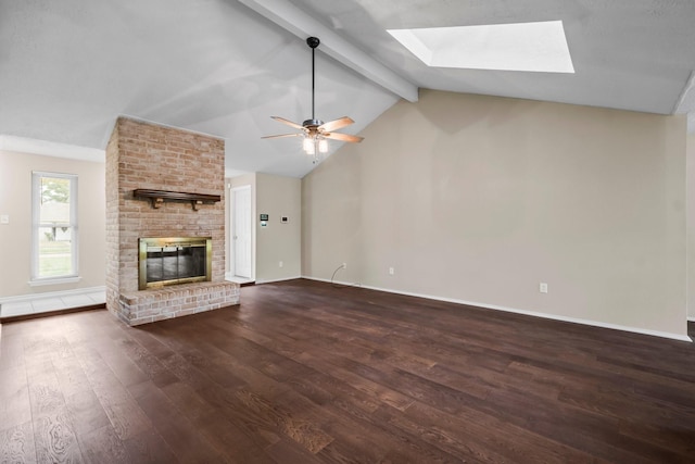 unfurnished living room with dark hardwood / wood-style floors, a brick fireplace, ceiling fan, and vaulted ceiling with skylight