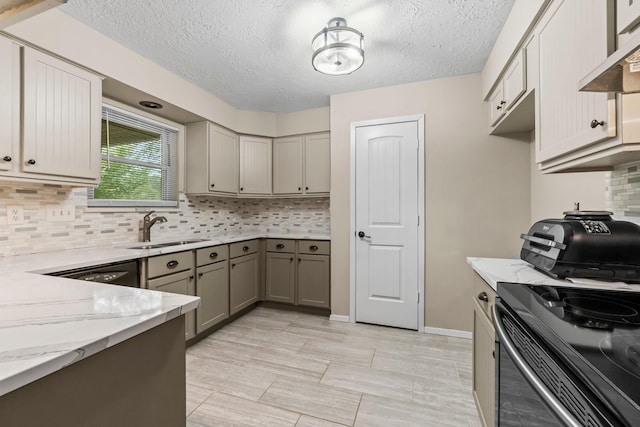 kitchen featuring gray cabinetry, sink, extractor fan, a textured ceiling, and black appliances