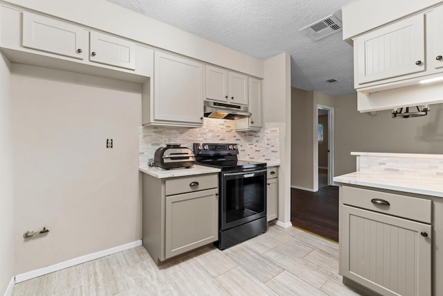 kitchen featuring backsplash, gray cabinetry, stainless steel range with electric cooktop, and a textured ceiling