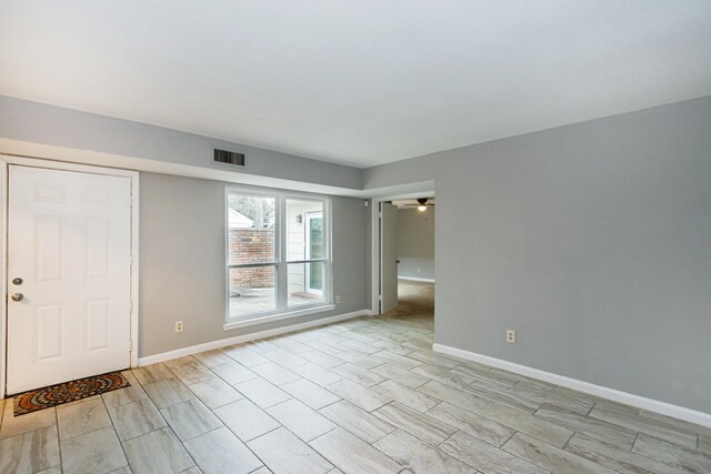 unfurnished room with ceiling fan