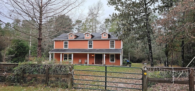 view of front of property featuring a front lawn and a porch