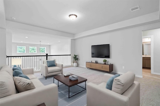 carpeted living room featuring sink