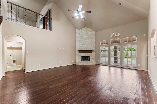 unfurnished living room featuring ceiling fan, hardwood / wood-style floors, a fireplace, and high vaulted ceiling