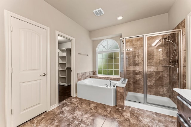 bathroom featuring independent shower and bath