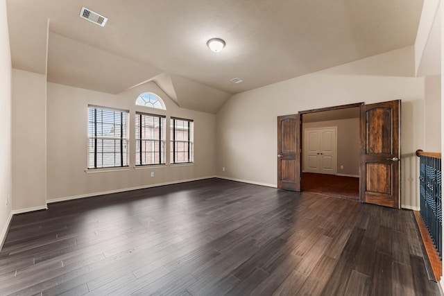 unfurnished living room with lofted ceiling and dark wood-type flooring