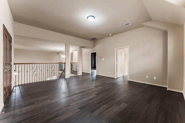 unfurnished living room with dark hardwood / wood-style flooring and vaulted ceiling