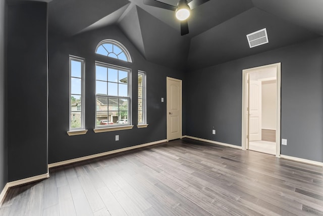 unfurnished bedroom with ceiling fan, wood-type flooring, and lofted ceiling