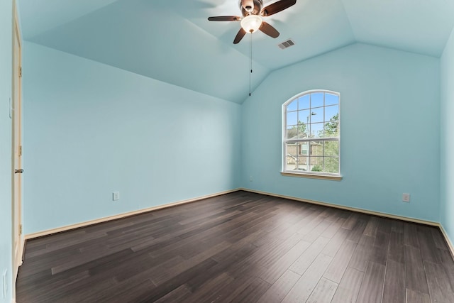 spare room featuring dark hardwood / wood-style flooring, vaulted ceiling, and ceiling fan