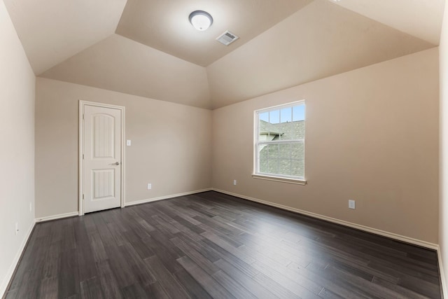 unfurnished room with lofted ceiling and dark hardwood / wood-style floors