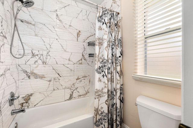 bathroom with shower / tub combo and toilet