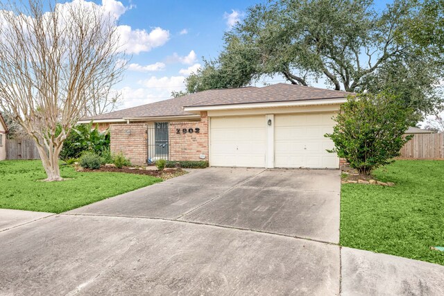 single story home with a garage and a front lawn