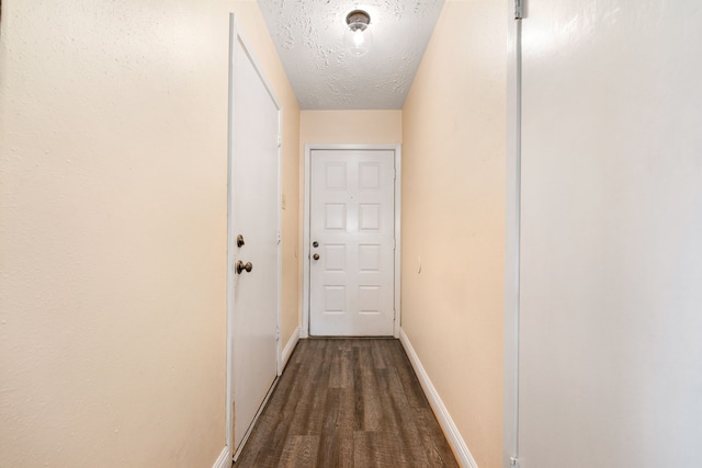 hall featuring hardwood / wood-style floors and a textured ceiling