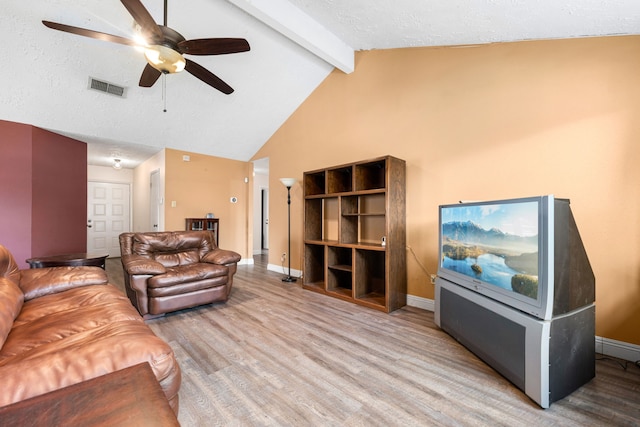 living room with vaulted ceiling with beams, a textured ceiling, wood-type flooring, and ceiling fan