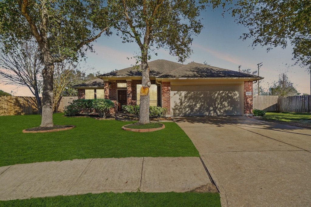 view of front of property with a lawn and a garage