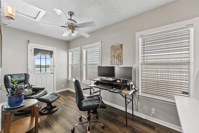 office space with ceiling fan, dark wood-type flooring, and a textured ceiling