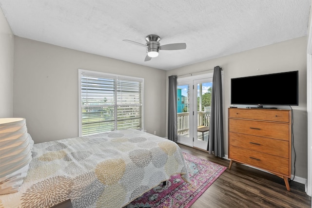 bedroom with ceiling fan, dark hardwood / wood-style floors, access to outside, and multiple windows