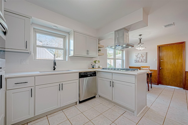 kitchen with white cabinetry, sink, stainless steel appliances, decorative light fixtures, and island range hood