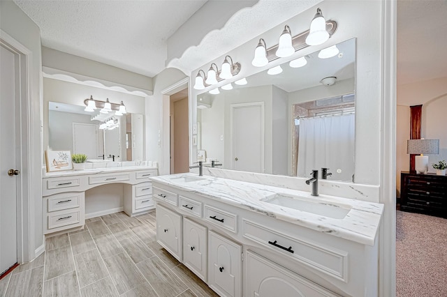 bathroom with vanity and a textured ceiling