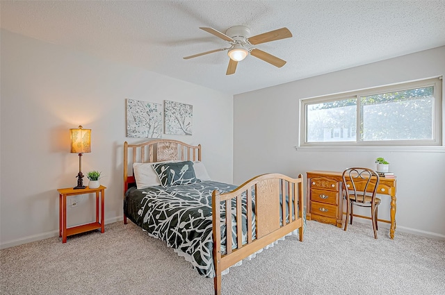 carpeted bedroom featuring a textured ceiling and ceiling fan