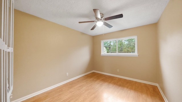 empty room featuring a textured ceiling, light hardwood / wood-style floors, and ceiling fan