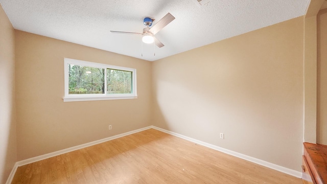 unfurnished room with ceiling fan, light hardwood / wood-style floors, and a textured ceiling