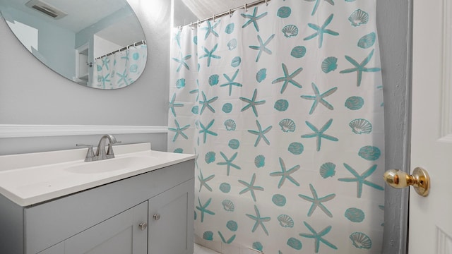 bathroom with vanity and walk in shower