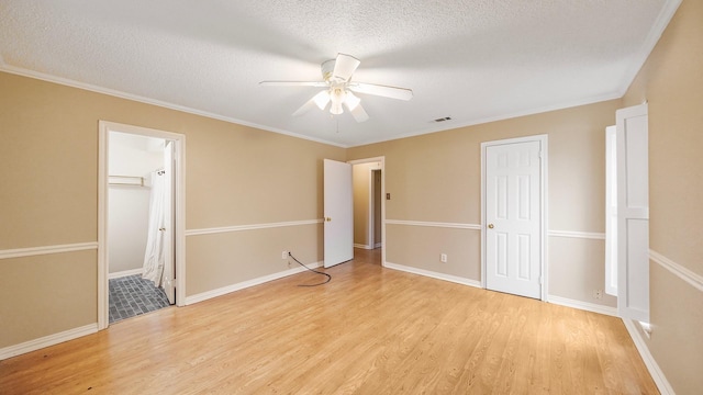 unfurnished bedroom featuring ceiling fan, light hardwood / wood-style floors, crown molding, and a textured ceiling