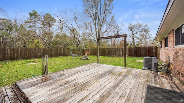 deck with a lawn and central air condition unit