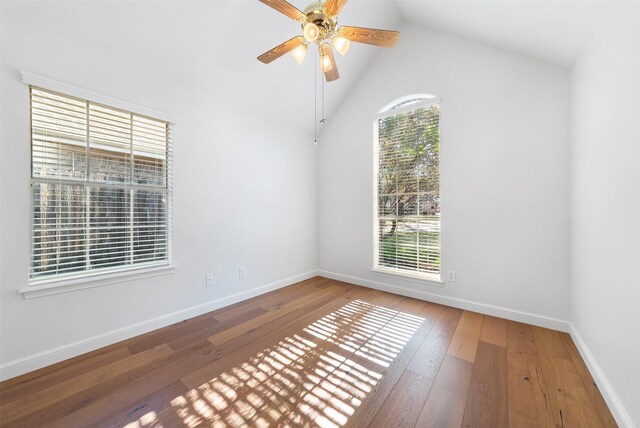 spare room featuring hardwood / wood-style floors, ceiling fan, and high vaulted ceiling