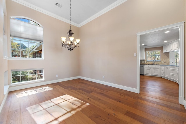 unfurnished dining area with ornamental molding, dark wood finished floors, visible vents, and baseboards