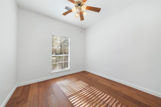 spare room with ceiling fan and hardwood / wood-style flooring