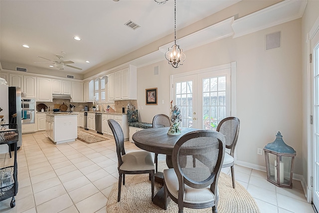 tiled dining room featuring ceiling fan with notable chandelier, crown molding, and french doors